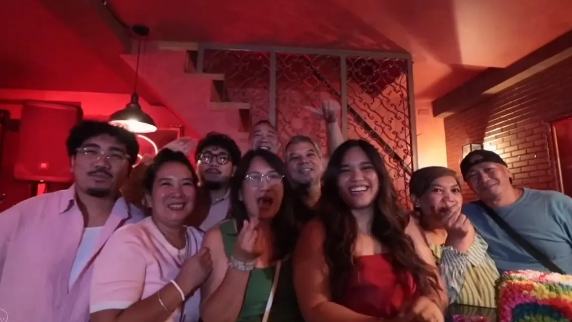 Friends crowding together for a group photo at a 30th birthday party