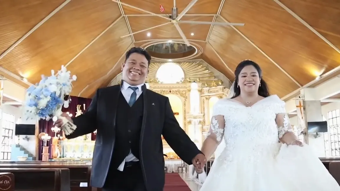 Bride and groom walking hand in hand down the church aisle after the ceremony
